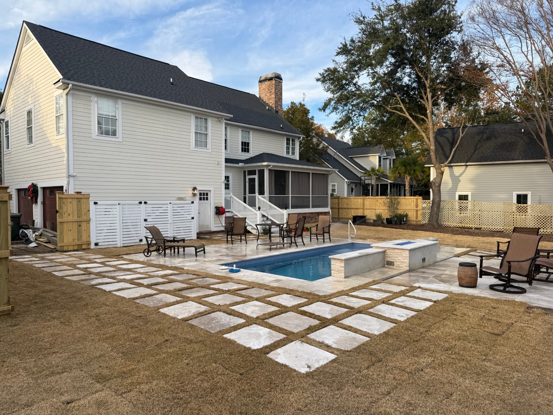 Completed backyard with paver grid, new sod, pool and fire feature